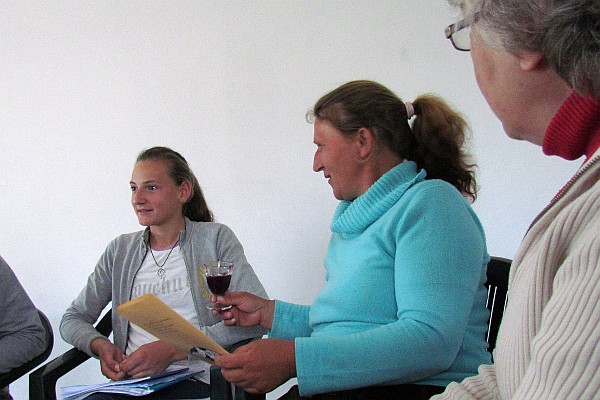 the oldest daughter, their mother, and Elsie share in communiion