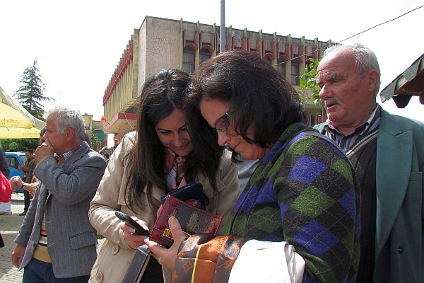 Klementina and another friend compare family photos