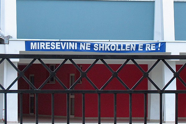 Welcome sign to the school behind us
