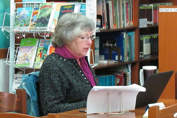 Elsie works in the library on a Macbook