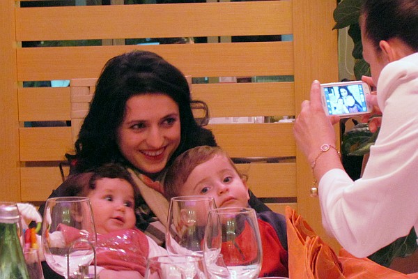 Alda holds both small children in her arms
