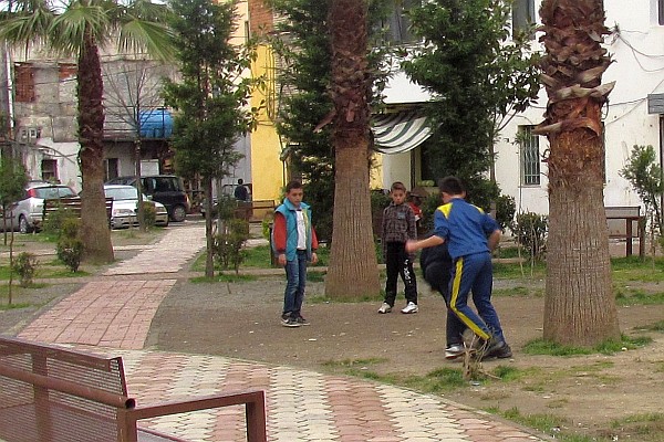 boys playing football (soccer) next to our building
