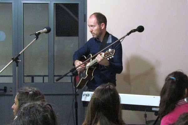 Robert Cook tuning up a guitar for worship on Easter morning