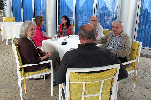 a table full of mission workers share over cxoffee