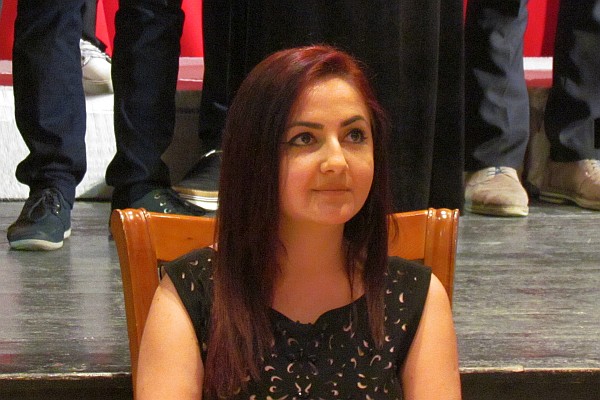 Xhorxhina sits waiting to interpret for speakers