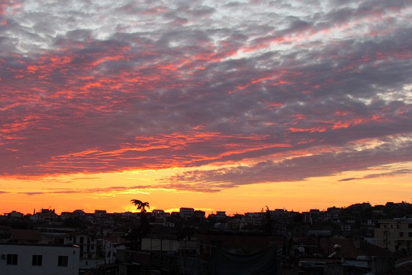 a yellow-orange-pink sunset in clouds over Lezhe