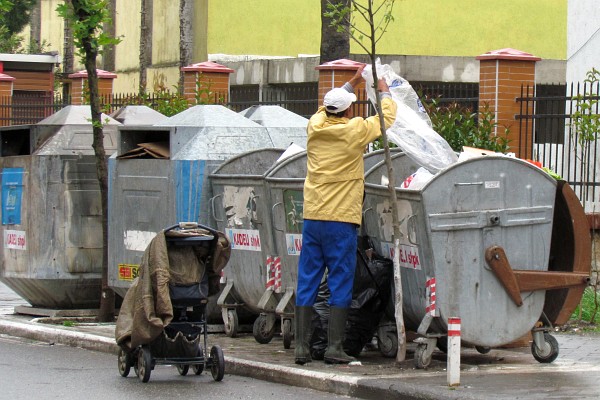 searching the trash for recyclables to earn money