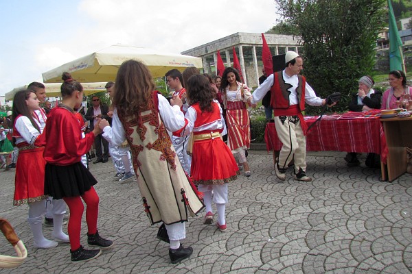 young people in traditional village dress dancing