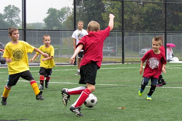 grandson Jared prepares to kick the soccer ball