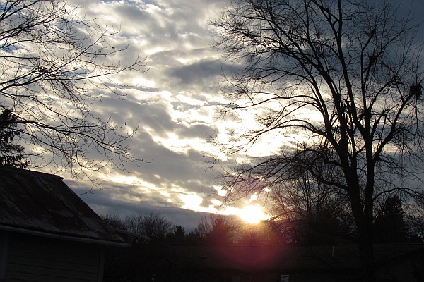 the bright and dark of a sunset with clouds