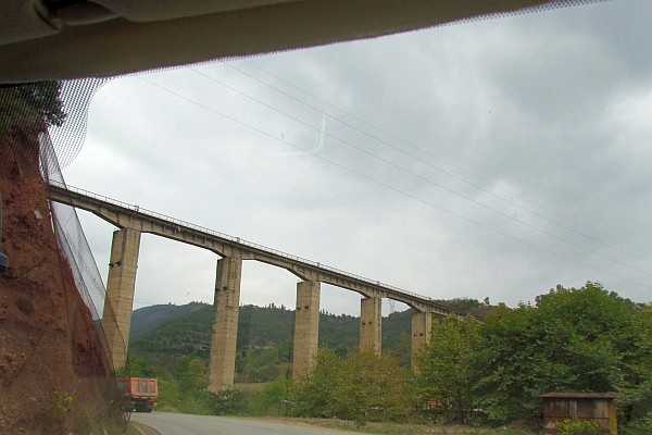 a very tall concrete train bridge