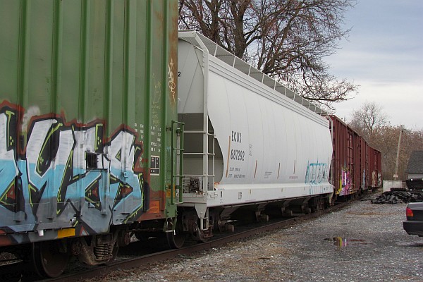 a string of four cars including the boxcar