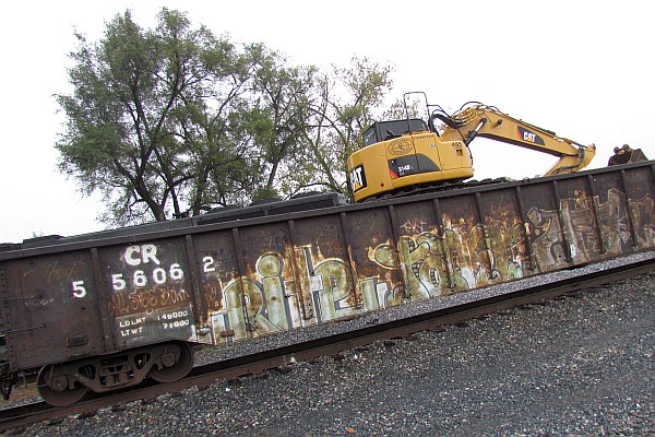 back-hoe on top of an old gondola car