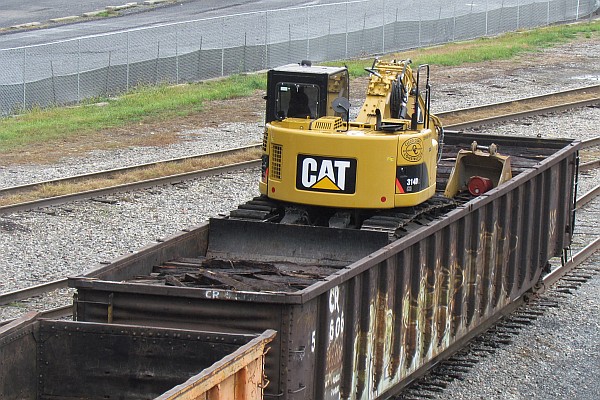 CAT back-hoe in gondola car