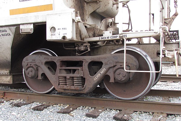 close-up of the 'trucks' of the covered hopper car